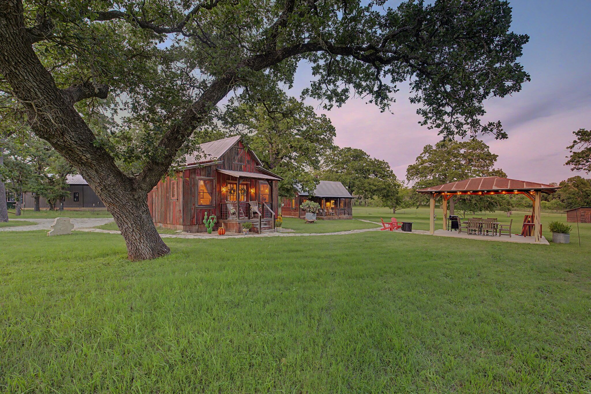 A rustic wooden building with a porch and outdoor seating area.