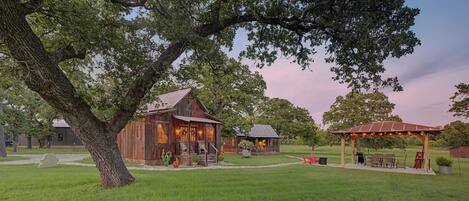 A rustic wooden building with a porch and outdoor seating area.