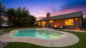 A backyard with a swimming pool, outdoor furniture, and string lights. - Nectar Nest, Video Tour, Pool, Spa, Fire Pit Arcade Game Room, King Master Suite (Hemet)