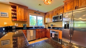 A kitchen with wooden cabinets, a stainless steel refrigerator, a microwave, and a dishwasher. - Fv49 Wow Stunning Single Level Home Next to Golf Course and Mt Washington Hotel (Bretton Woods)