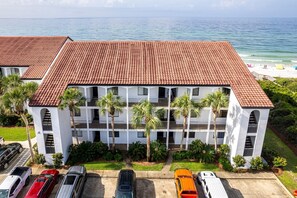 A multi-story hotel with a red-tiled roof, white exterior walls, and multiple balconies.