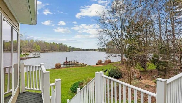 A porch with a view of a lake, a dock, and a boat. - Lake Days Getaway - Lakeside Family Escape Near Hillsborough (Hillsborough)