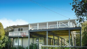 A two-story house with a balcony, a basketball hoop, and a covered outdoor area. - Coastal Haven, 5 minute walk to beach. (Flinders)