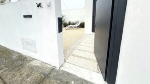 A white building with a black door and a number '46' on the wall. - Espinho Beach House by Trip2Portugal (Espinho)