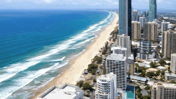 A coastal cityscape with high-rise buildings, a beach, and a clear sky. - Level 42 Beachside 1BR Apartment with Ocean Views (Surfers Paradise)