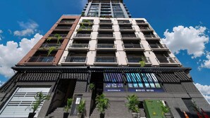 A multi-story building with balconies, a website address, and a contact number. - Apartment Upper Level in Casco View (Panamá)