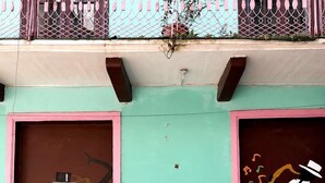 A person walking past a building with colorful murals on the facade. - Apartment Lower Level (Panama City)