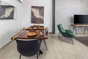 A modern dining area with a wooden table, chairs, and artwork on the walls. - Penthouse with Amador bay views and dual balconies (Panama City)