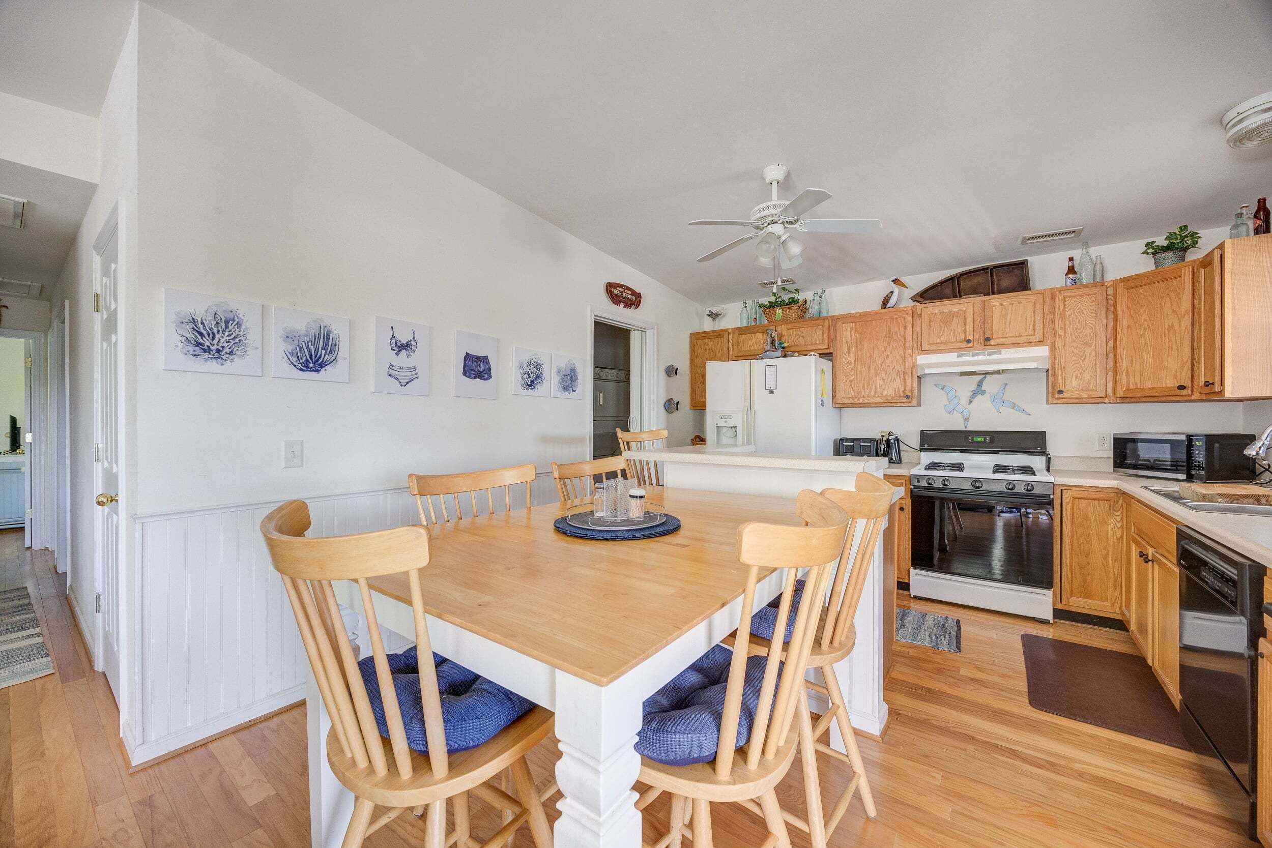 A kitchen with wooden cabinets, a white refrigerator, a stove, and a microwave.