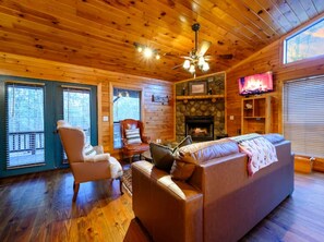 TV, fireplace - Bonfire View · Fireside Retreat: Hot Tub, Deck, Fireplace (Broken Bow)