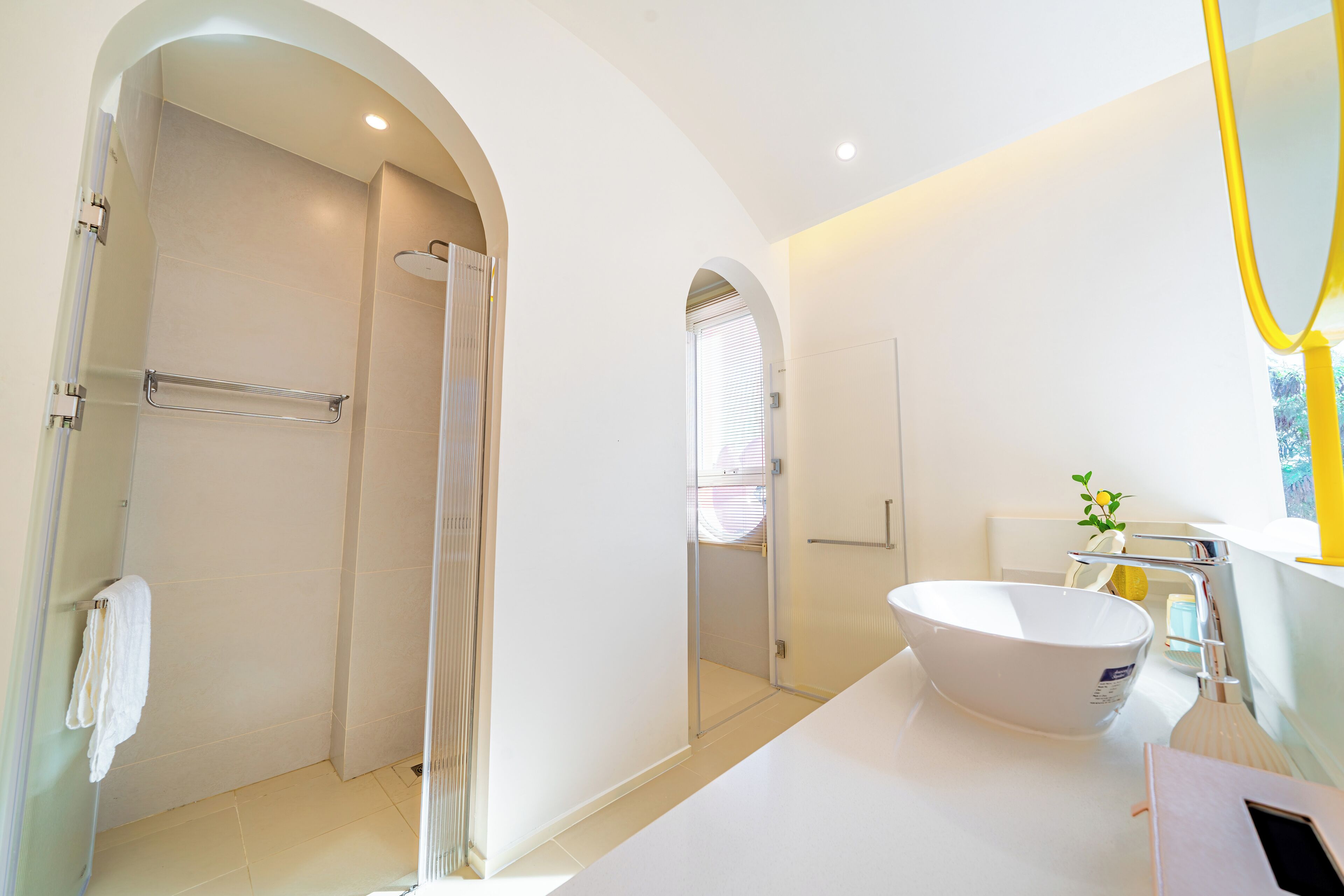 A modern bathroom with a shower, a sink, and a mirror.