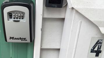 A door with a Master Lock device and a doorbell.