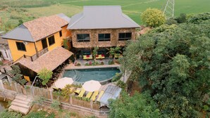 A two-story house with a swimming pool, surrounded by greenery and a view of the countryside. - Ninh Binh Rustic Hideaway (Nam Hoa Lu)