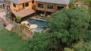 A house with a swimming pool, surrounded by lush greenery and a river. - Ninh Binh Rustic Hideaway (Nam Hoa Lu)