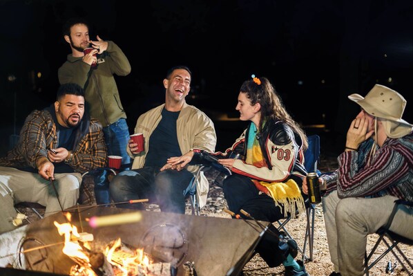 A group of people sitting around a campfire at night. - Starlight Horizon 2 Cabins (3 Bed Each) Pool, Firepits, Sleeps up to 16 (Canyon Lake)