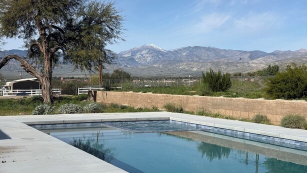 A swimming pool with a mountain view, a tree, and a fence. - Fire Horse Ranch Desert Hot Springs Ca (Desert Hot Springs)