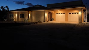 A two-story house with a garage, a covered porch, and a staircase leading to the second floor. - Fire Horse Ranch Desert Hot Springs Ca (Desert Hot Springs)