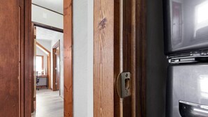 A hallway with wooden doors and a stainless steel appliance, likely a refrigerator, on the right. - Farmhouse less than a mile from beaches (Millcreek Township)