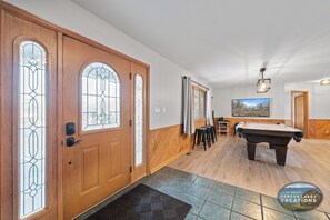 A spacious room with a pool table, wooden doors with stained glass, and a framed picture on the wall. - Pickleball Court | Lake Views | Pool Table | Sleeps 10 (Twin Lakes)