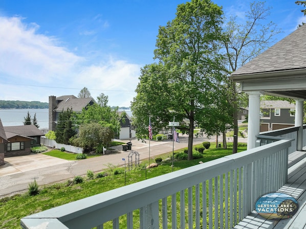 A residential area with a view of a lake, houses, and a gazebo.