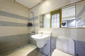 A bathroom with a white sink, a glass shower enclosure, and a mirror with a heart-shaped decoration. - Cheongju Hotel Persona (Cheongju)