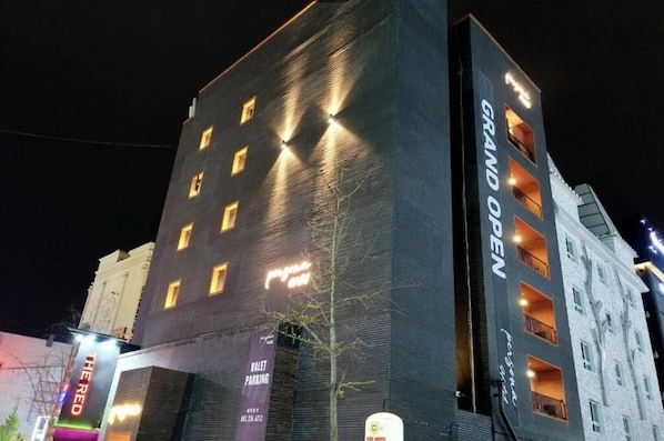 A multi-story building with illuminated windows and balconies, labeled "Grand Open." - Cheongju Hotel Persona (Cheongju)