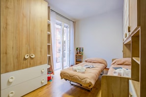 A bedroom with a bed, two bedside tables, a wardrobe, and a window. - Asia Apartment 2BR in Laveno Center, Laveno Mombello, Italy (Laveno Mombello)