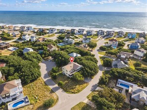A residential area with houses, a swimming pool, and a view of the ocean. - FUNNY DUCK - 4 BR Oceanside Home w/Private Pool (Duck)