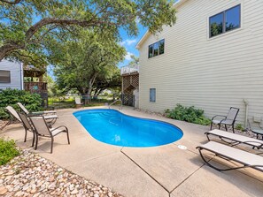 A residential backyard with a swimming pool, lounge chairs, and a wooden deck. - FUNNY DUCK - 4 BR Oceanside Home w/Private Pool (Duck)