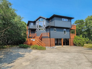 A two-story building with a wooden staircase and a balcony. - GONE COASTAL - 5 BR Hone in Southern Shores w/Private Pool & Hot Tub (Southern Shores)