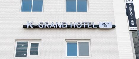 A hotel sign with 'K-GRAND HOTEL' and 'DDP 3F' indicating the building's name and floor.
