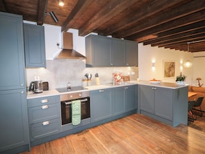 A modern kitchen with grey cabinets, a built-in oven, and wooden flooring. - THE LOFT, family friendly, with a garden in Glenmore, County Kilkenny (Kilkenny)