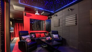 A modern room with red accents, a projector, and soundproofing panels. - Cinéma Provence - Air-conditioned - 7ᵉ art (Avignon)