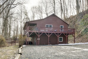 A two-story building with a balcony, surrounded by trees and gravel. - ‘Raley's Retreat’ w/ Hot Tub: 2 Mi to Dtwn Boone! (Boone)