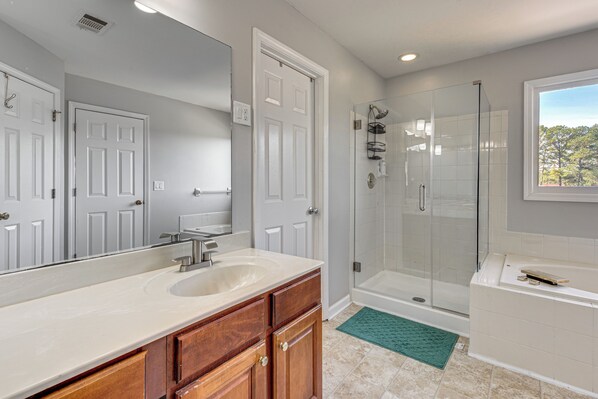 A bathroom with a sink, mirror, shower, and bathtub. - Outdoor Kitchen! Spacious Stone Mountain Retreat (Stone Mountain)
