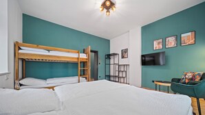 A room with two bunk beds, a desk, a chair, and a TV. - Apartment at Linden Square - Trutnov (Trutnov)