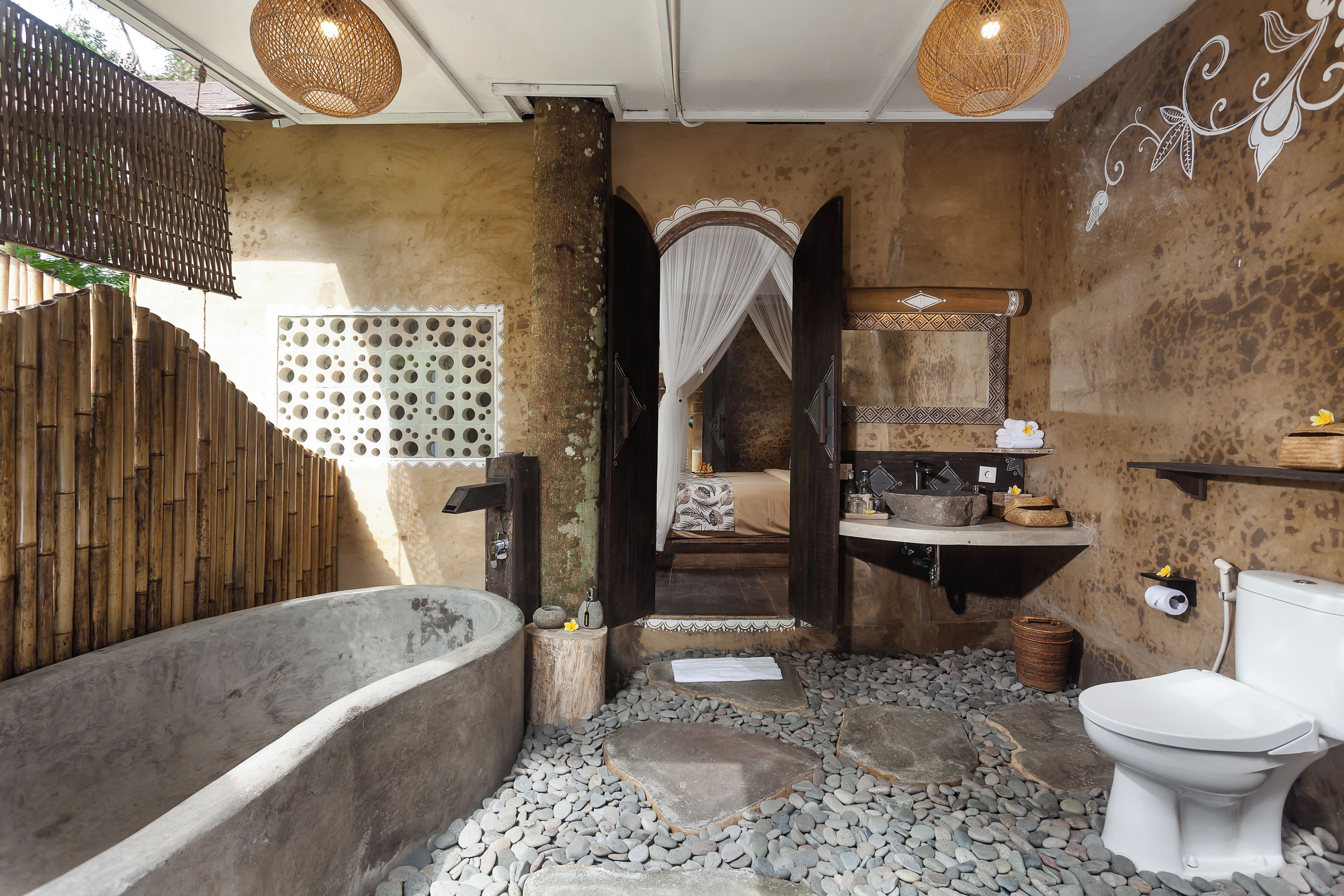 A bathroom with a bathtub, a toilet, a sink, and a shower area.