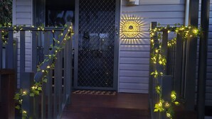 A wooden staircase leading to a door with a decorative light pattern above it.