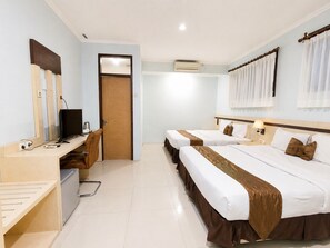 A hotel room with two beds, a desk with a computer, a chair, and a door. - Scarlet Hotel Stasiun Bandung (Bandung)