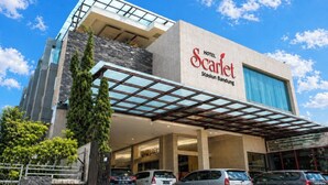 A hotel named 'Scarlet' with a modern architectural design, featuring a prominent entrance and a covered parking area. - Scarlet Hotel Stasiun Bandung (Bandung)