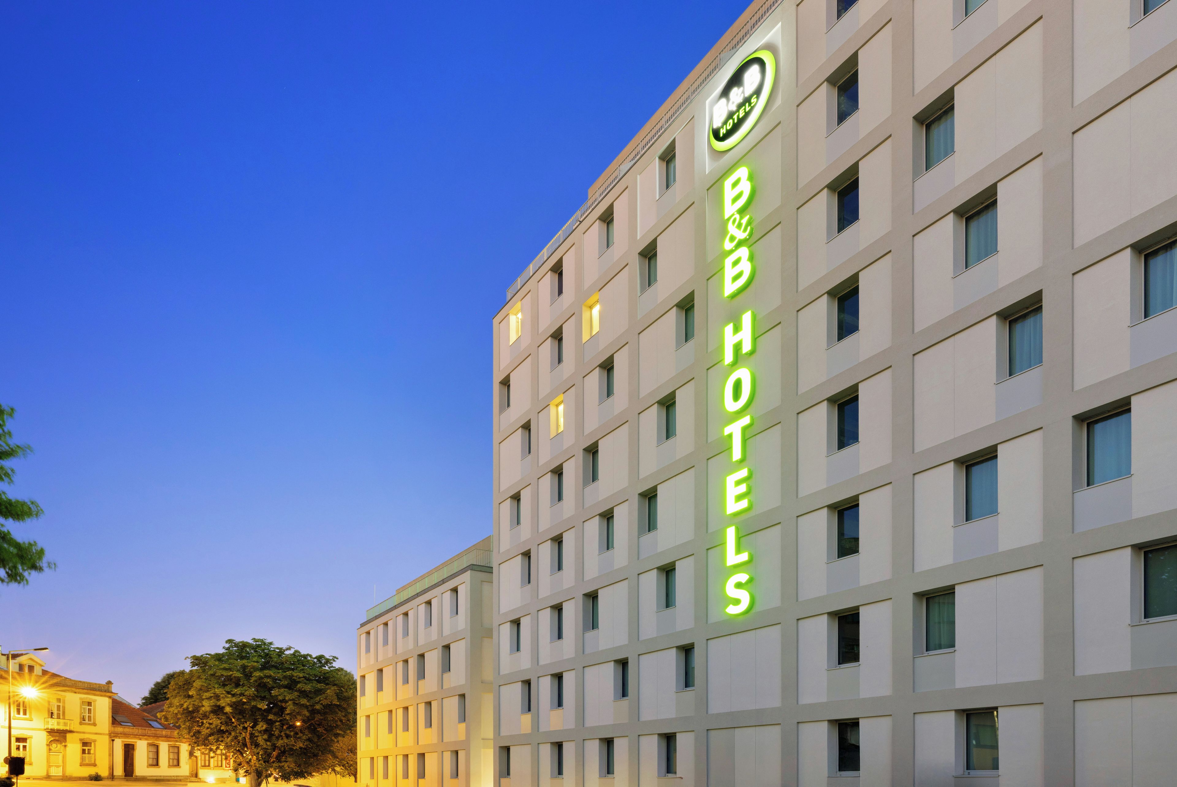 A multi-story hotel building with a prominent sign for B&B Hotels.