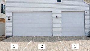 A two-story white house with two garage doors and a driveway with three numbered parking spaces. - 'Bentwood Escape' 
Modern unit in heart of Yamba (Yamba)