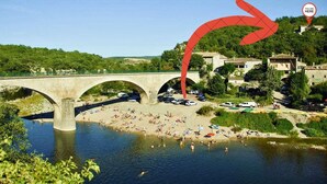 A stone bridge over a river with a beach and parked cars. - In Balazuc, terrace overlooking the Ardèche gorges, 300 m from the beach. (Balazuc)