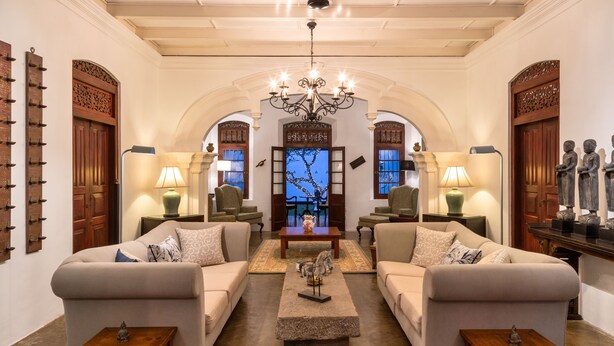 A spacious living room with two sofas, a coffee table, and a chandelier. - Clingendael Weligama (Weligama)