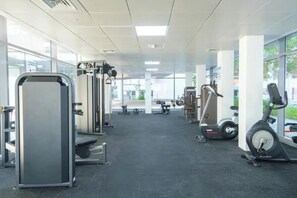 A gym with various exercise equipment, including a treadmill, weight machines, and a bench. - Bloomfields Stunning STU The Gate Masdar (Abu Dhabi)