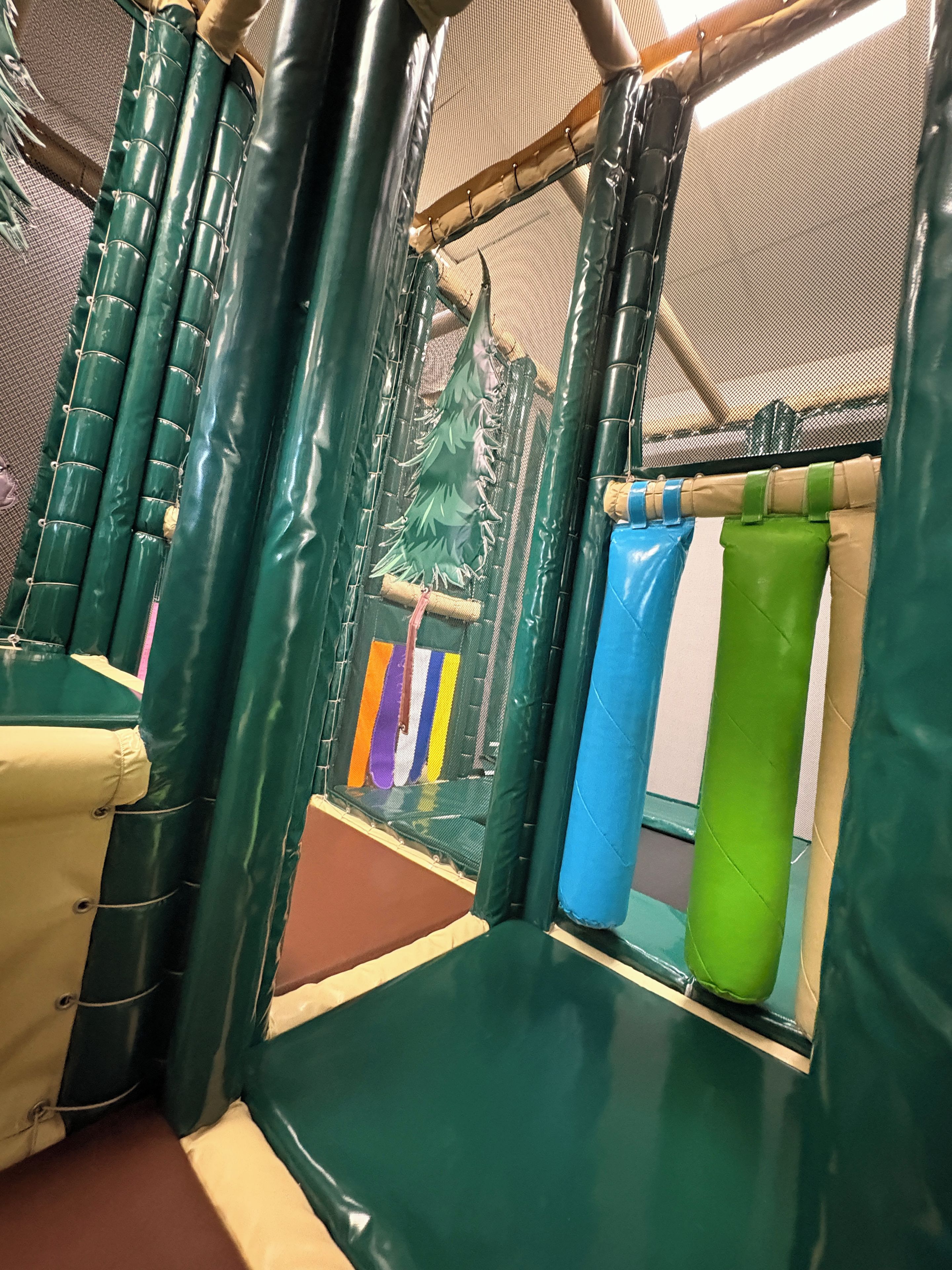 Un espace de jeux intérieur avec des murs et un sol recouverts de matériaux amortissants.