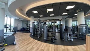 A gym with cardio equipment, weight machines, and a wooden floor. - Lux Ellipse Galelileo (Midrand)