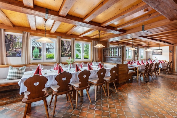 A dining area with wooden tables and chairs, large windows, and a wooden ceiling. - Holiday Apartment '5' with Mountain View and Wi-Fi (Sankt Blasien)
