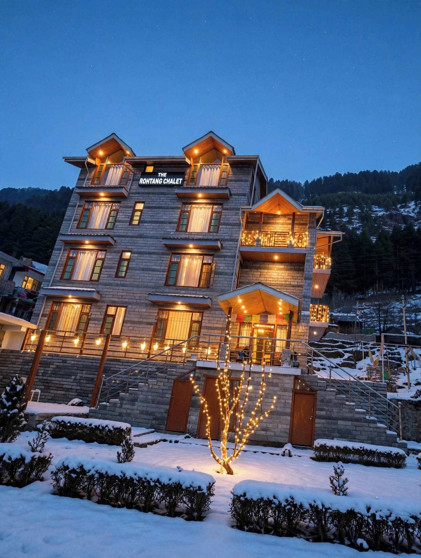 A multi-story hotel with a sign reading 'The Rohtang Chalet.'