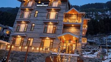 A multi-story hotel with a sign reading 'The Rohtang Chalet.'